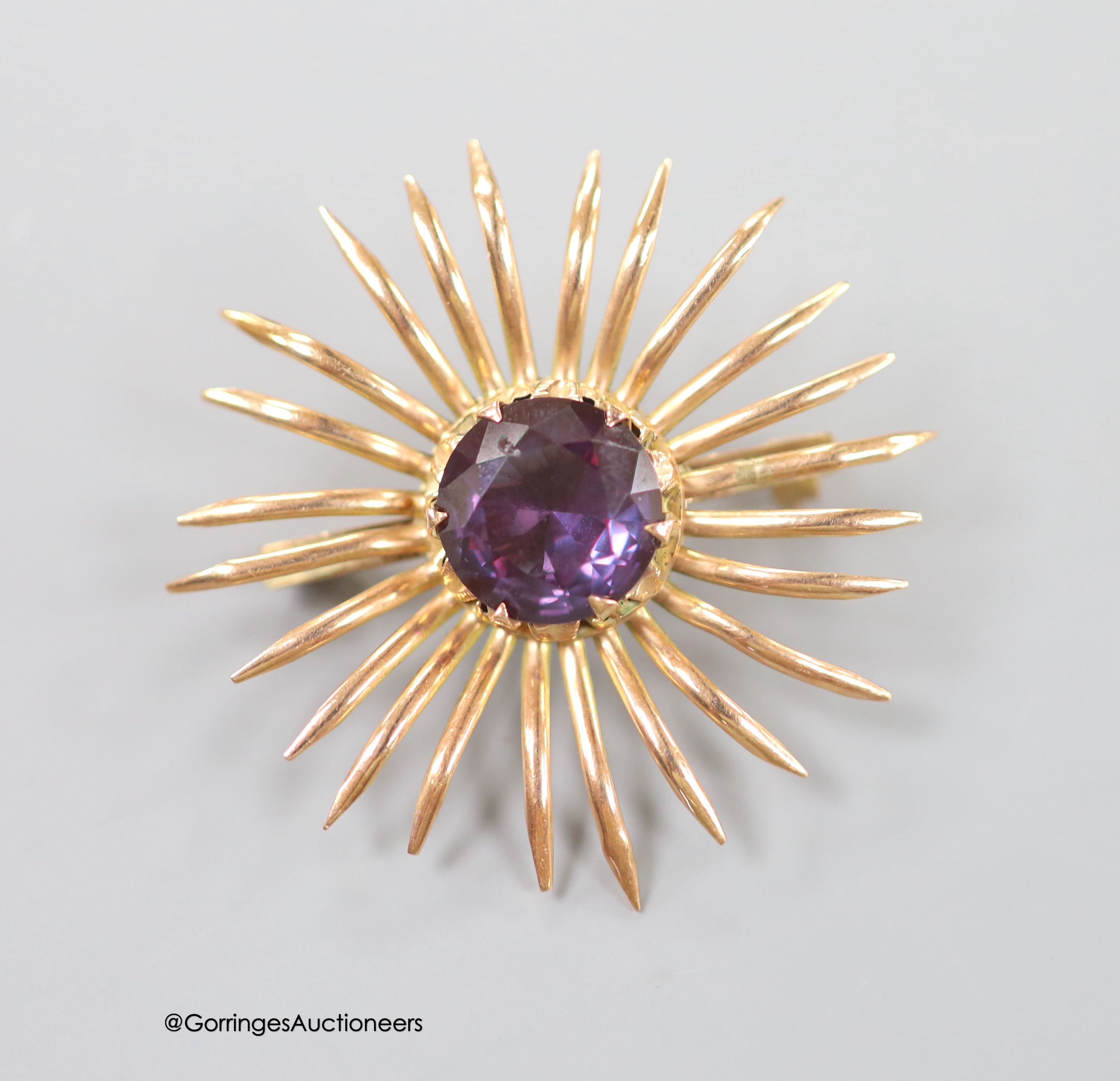 A Middle Eastern yellow metal and synthetic colour change corundum set brooch, 41mm, gross weight 6.9 grams (pin missing).